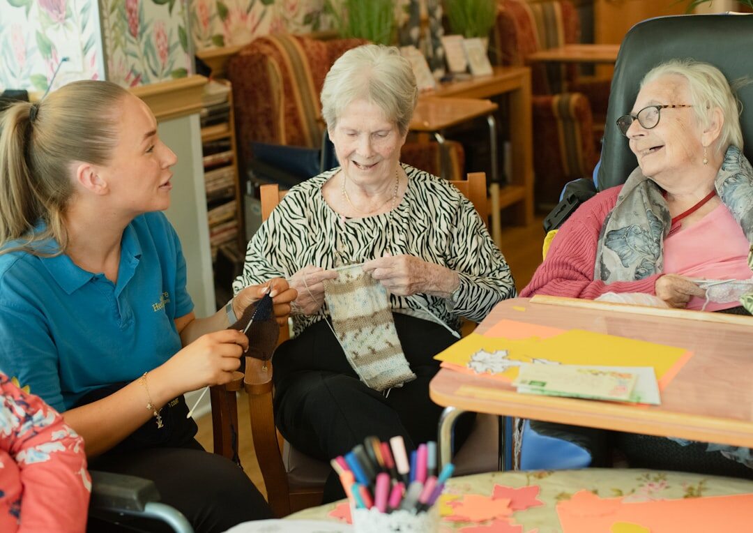 elderly woman knitting with friends