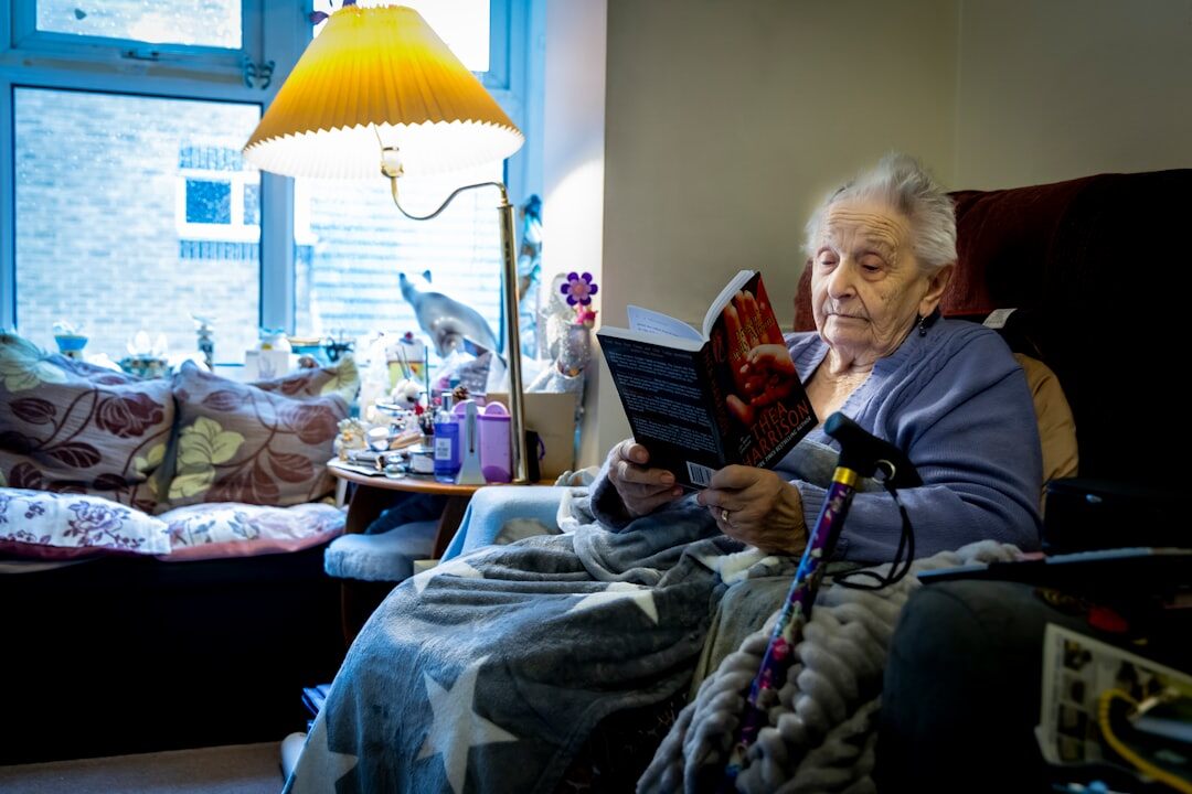 senior man reading book in armchair