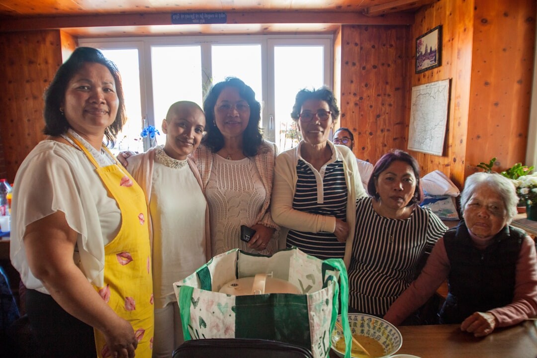 Senior citizens cooking together in a community kitchen